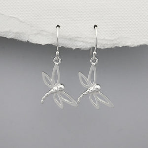 Silver dragonfly earrings on a white and gray background